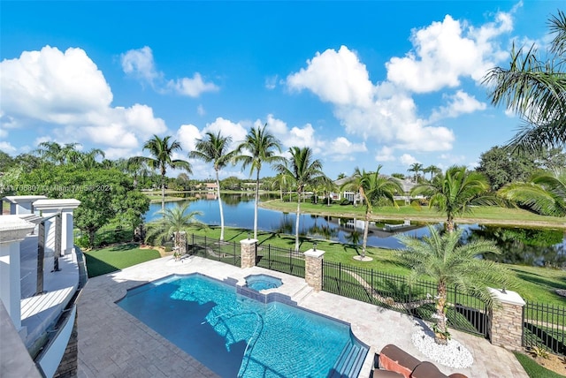 view of swimming pool with a lawn, an in ground hot tub, a water view, and a patio