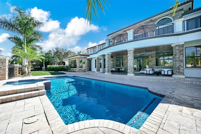 view of pool featuring a patio area, an in ground hot tub, and ceiling fan