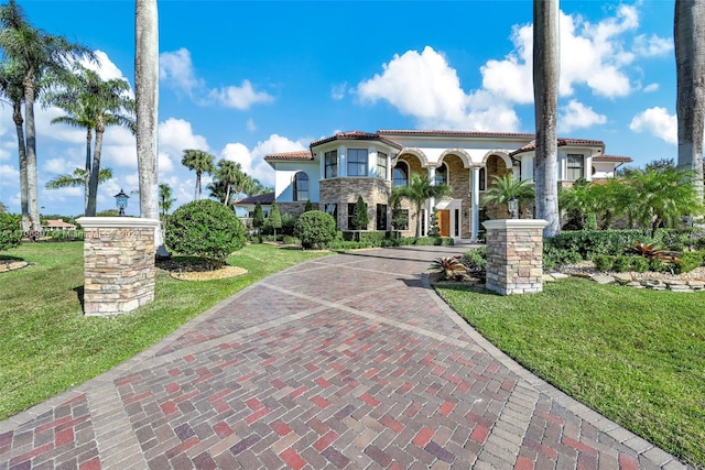 mediterranean / spanish-style house with a front lawn