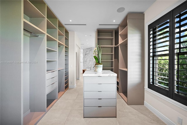 spacious closet with light tile patterned floors