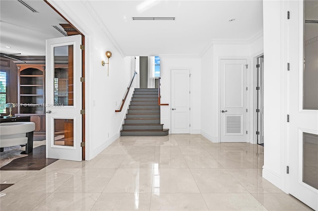 hallway featuring french doors and ornamental molding