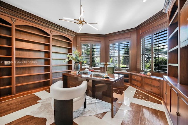 office featuring wood walls, light tile patterned flooring, crown molding, and a chandelier