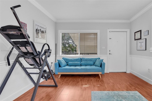 exercise room featuring hardwood / wood-style floors and crown molding