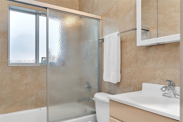 full bathroom with plenty of natural light, toilet, enclosed tub / shower combo, and vanity