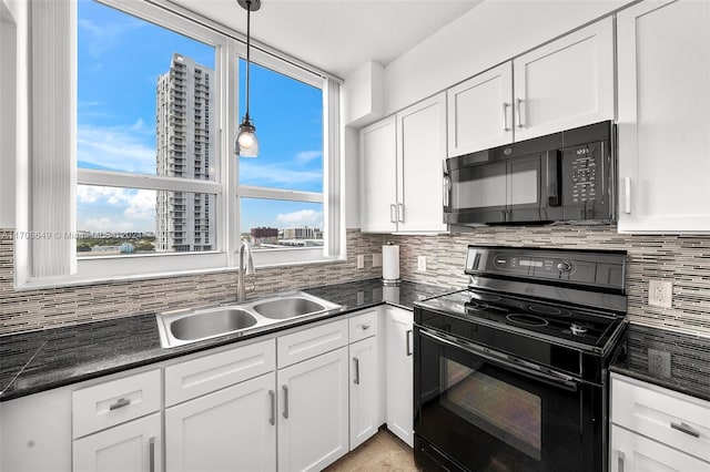 kitchen with black appliances, white cabinets, sink, hanging light fixtures, and tasteful backsplash