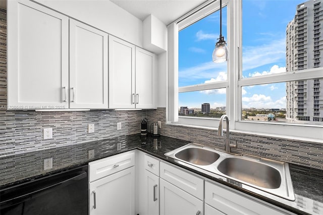 kitchen with sink, black dishwasher, pendant lighting, decorative backsplash, and white cabinets