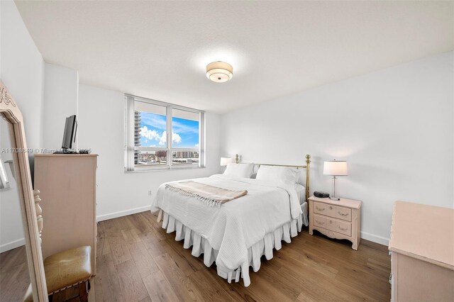 bedroom with hardwood / wood-style flooring