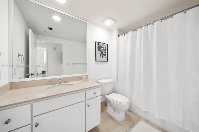 full bathroom featuring tile patterned flooring, shower / bath combo, vanity, and toilet