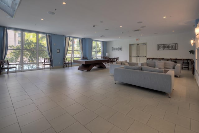 tiled living room featuring expansive windows and pool table