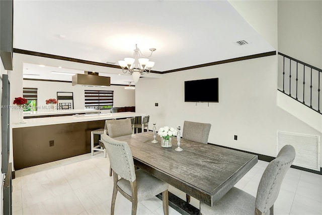 dining space featuring ornamental molding and a chandelier