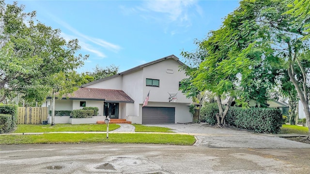 view of front of property featuring a garage and a front yard