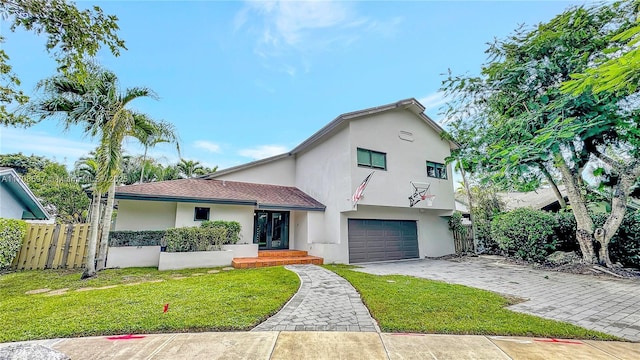 view of front facade with a garage and a front lawn