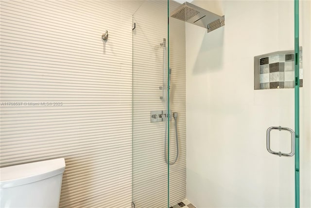 bathroom featuring an enclosed shower and toilet