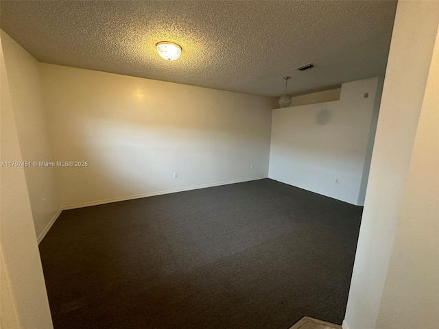 2306 SE 23rd Ter Unit 2306, Homestead, FL 33035 - empty room featuring dark carpet and a textured ceiling