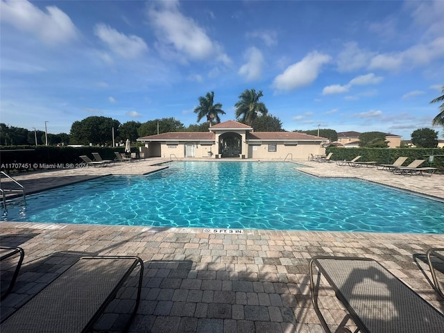 view of swimming pool with a patio area