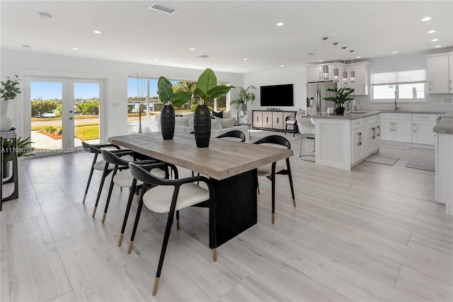 dining space with light hardwood / wood-style floors