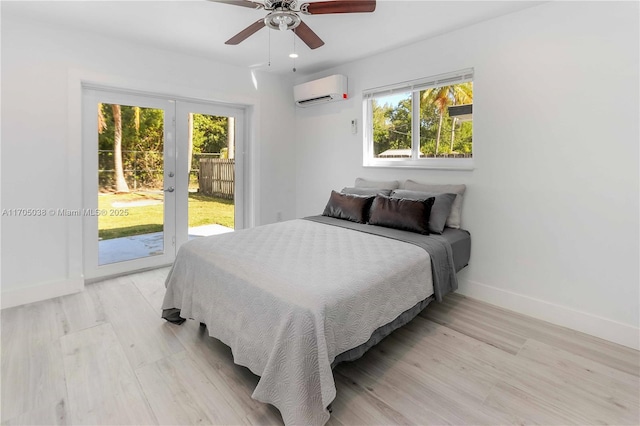 bedroom with a wall mounted AC, ceiling fan, light hardwood / wood-style flooring, and access to exterior