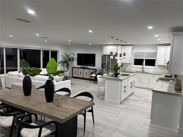 dining room with sink and light hardwood / wood-style floors