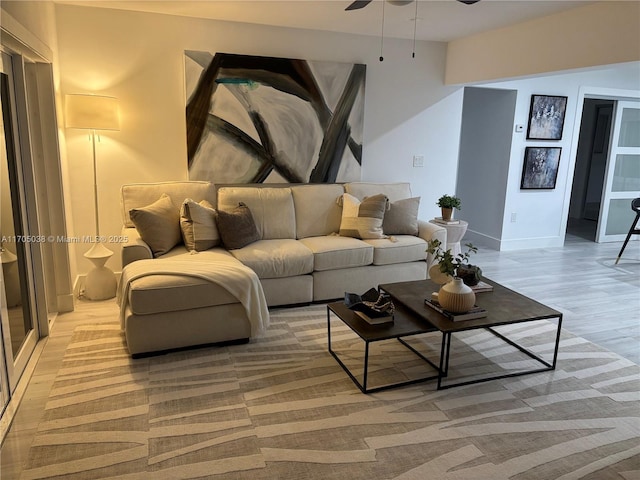 living room featuring light wood-type flooring and ceiling fan