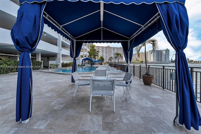 view of patio / terrace featuring a gazebo and a community pool