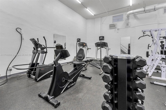 workout area featuring a wall unit AC