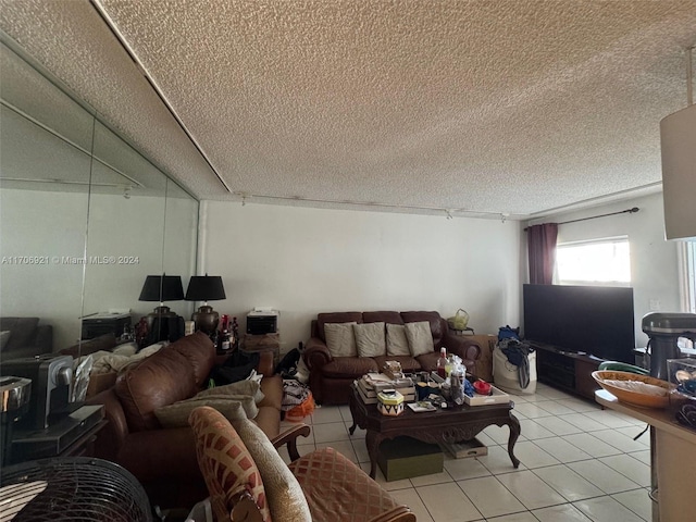 living room with light tile patterned floors and a textured ceiling