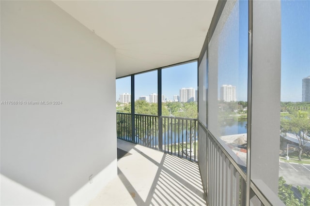 sunroom / solarium with a water view and a healthy amount of sunlight