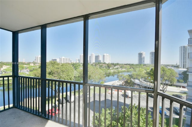 unfurnished sunroom featuring a water view