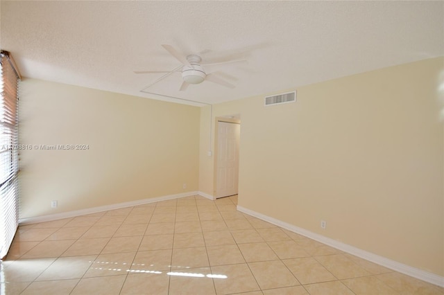 tiled spare room featuring ceiling fan and a textured ceiling