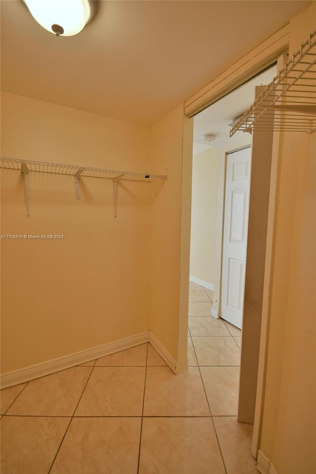 walk in closet with tile patterned flooring