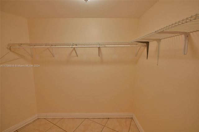 spacious closet featuring light tile patterned flooring