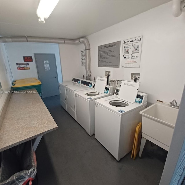 washroom with washer and dryer and sink