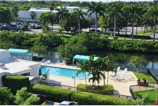 view of pool featuring a patio area and a water view