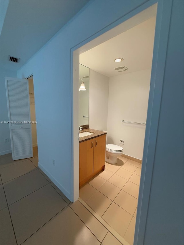 bathroom featuring toilet, vanity, and tile patterned floors