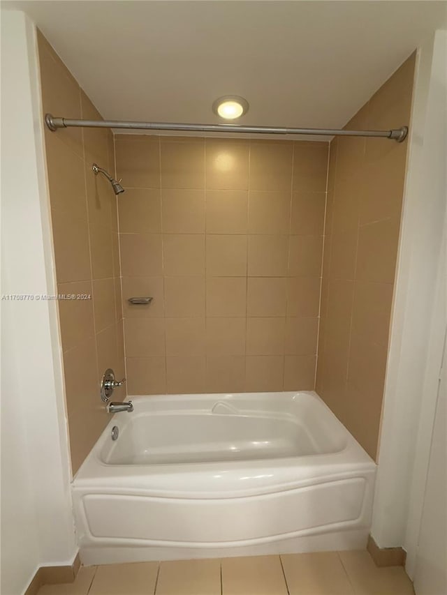 bathroom featuring tile patterned flooring and tiled shower / bath