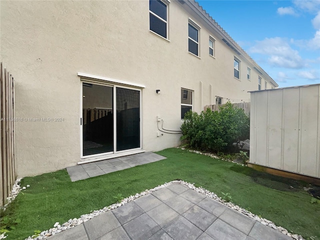 back of house featuring a yard and a patio area