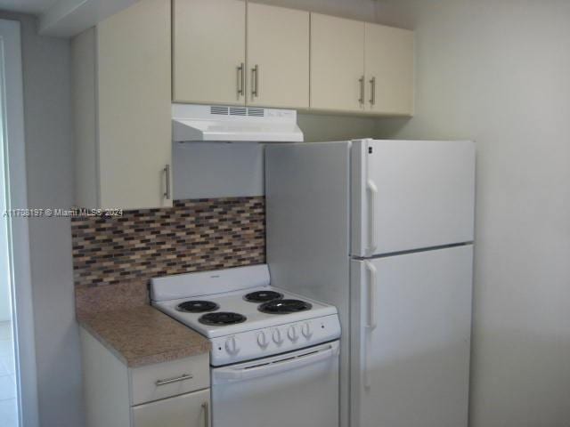 kitchen with white cabinetry, white appliances, and backsplash