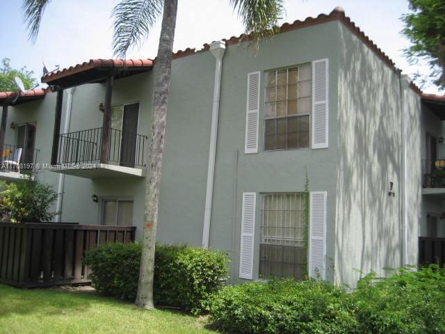 10776 N Kendall Dr Unit F-16, Miami, FL 33176 - view of side of property with stucco siding, a tiled roof, and a balcony