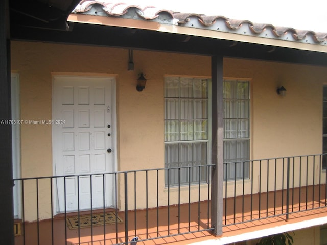 10776 N Kendall Dr Unit F-16, Miami, FL 33176 - view of exterior entry featuring stucco siding and covered porch