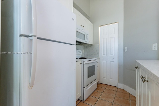 kitchen featuring white cabinetry, white appliances, backsplash, and light tile patterned floors