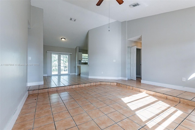 unfurnished room with light tile patterned floors, french doors, ceiling fan, and lofted ceiling