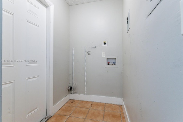 washroom featuring hookup for an electric dryer, light tile patterned flooring, and washer hookup