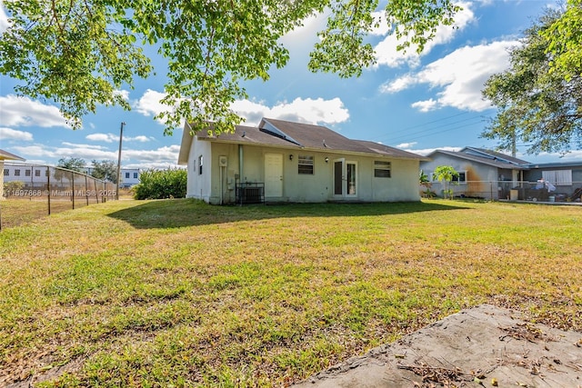 back of property featuring a yard