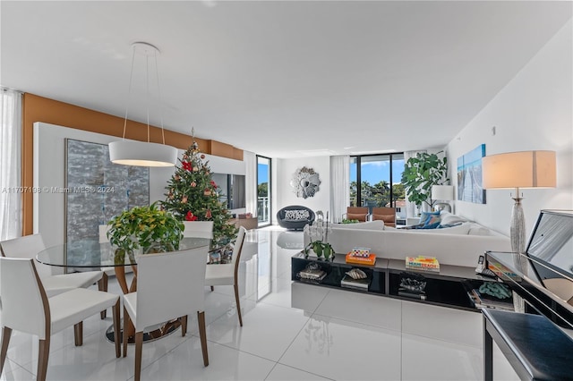 dining area featuring light tile patterned flooring and a wall of windows