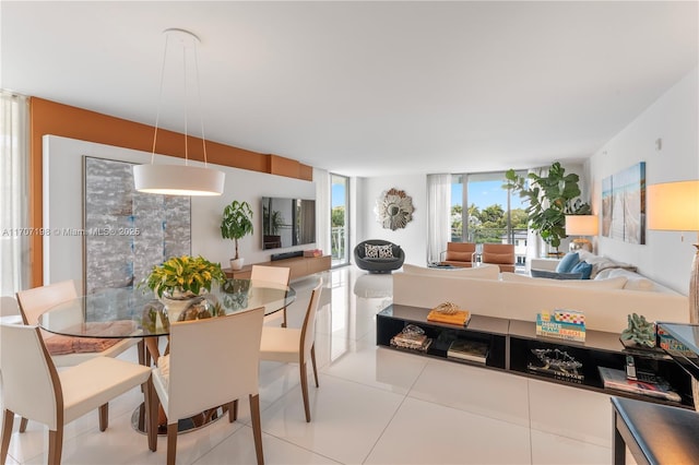 dining space with a wall of windows and tile patterned flooring