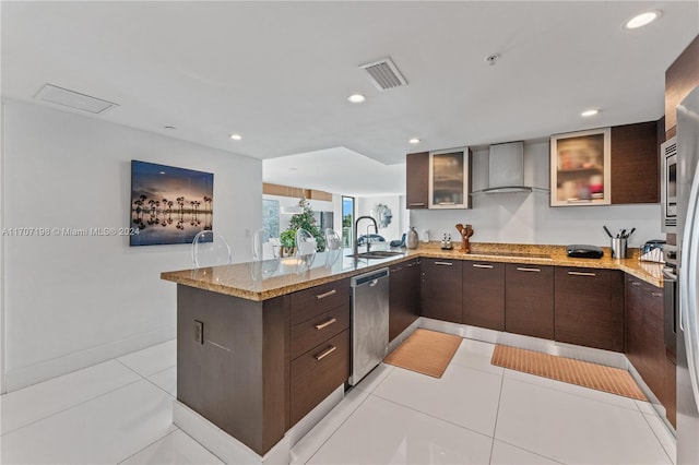 kitchen with dishwasher, black electric stovetop, sink, wall chimney exhaust hood, and kitchen peninsula