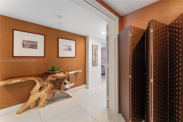 hall with tile patterned floors