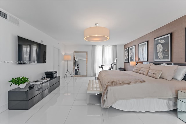 bedroom featuring light tile patterned floors and visible vents