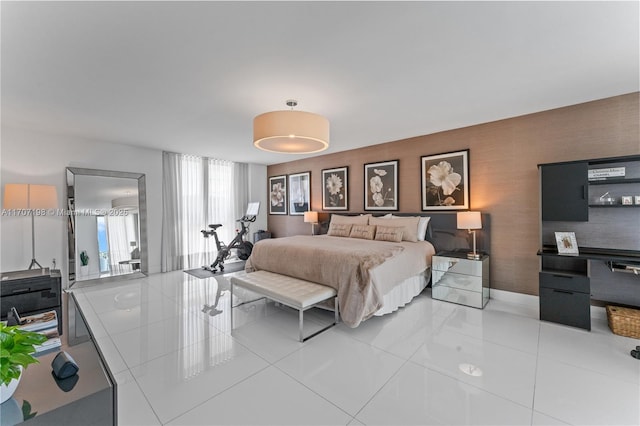 bedroom featuring light tile patterned flooring and baseboards