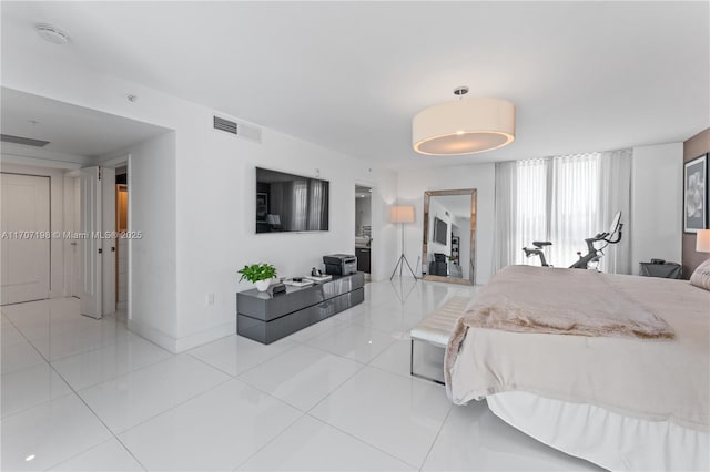 tiled bedroom with visible vents and baseboards